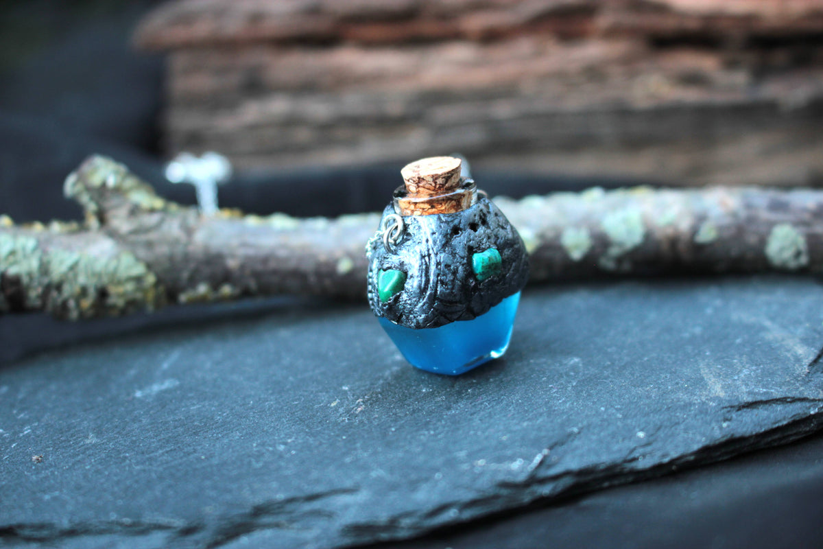 Blue potion pendant glowing in the dark, handmade fantasy jewelry
