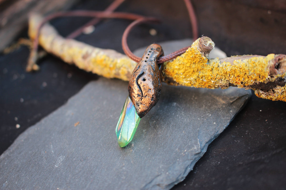 Green glowing pendant with mystical forest design