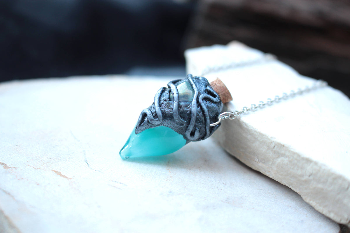 Handmade turquoise potion bottle necklace with a magical green glow