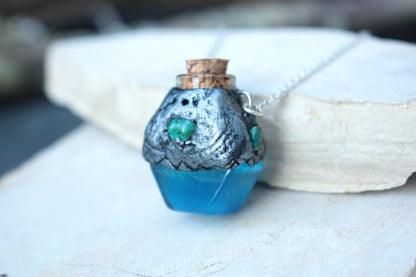 Tiny glowing blue potion bottle necklace with intricate handmade details