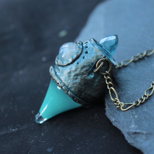 Glowing turquoise potion pendant necklace with a mystical fantasy design