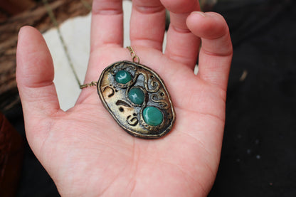Handmade pendant combining natural gemstones with ancient fantasy aesthetics