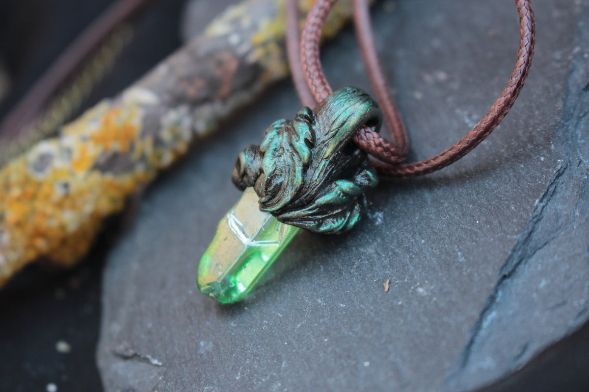 Fantasy pendant featuring an iridescent green crystal