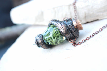 Handmade green vial necklace with rustic woodland-inspired details