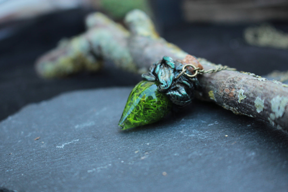 Handmade green moss vial necklace with an antique bronze finish