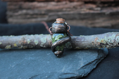 Handmade green potion vial pendant with rustic bark-like wrapping and copper chain