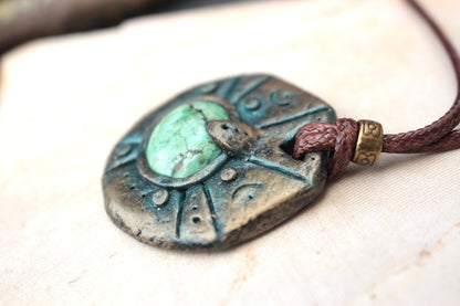 Detailed view of the green stone centerpiece surrounded by an antique patina frame