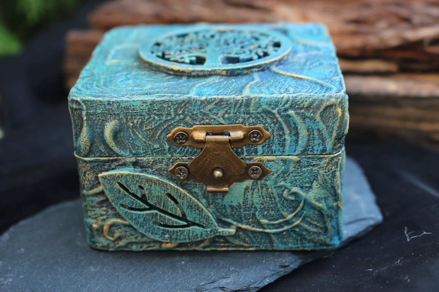 Small handcrafted wooden jewelry box painted in bluish green with a subtle golden shimmer