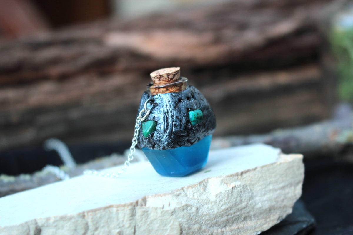 Handmade polymer clay blue potion pendant with glass and resin details