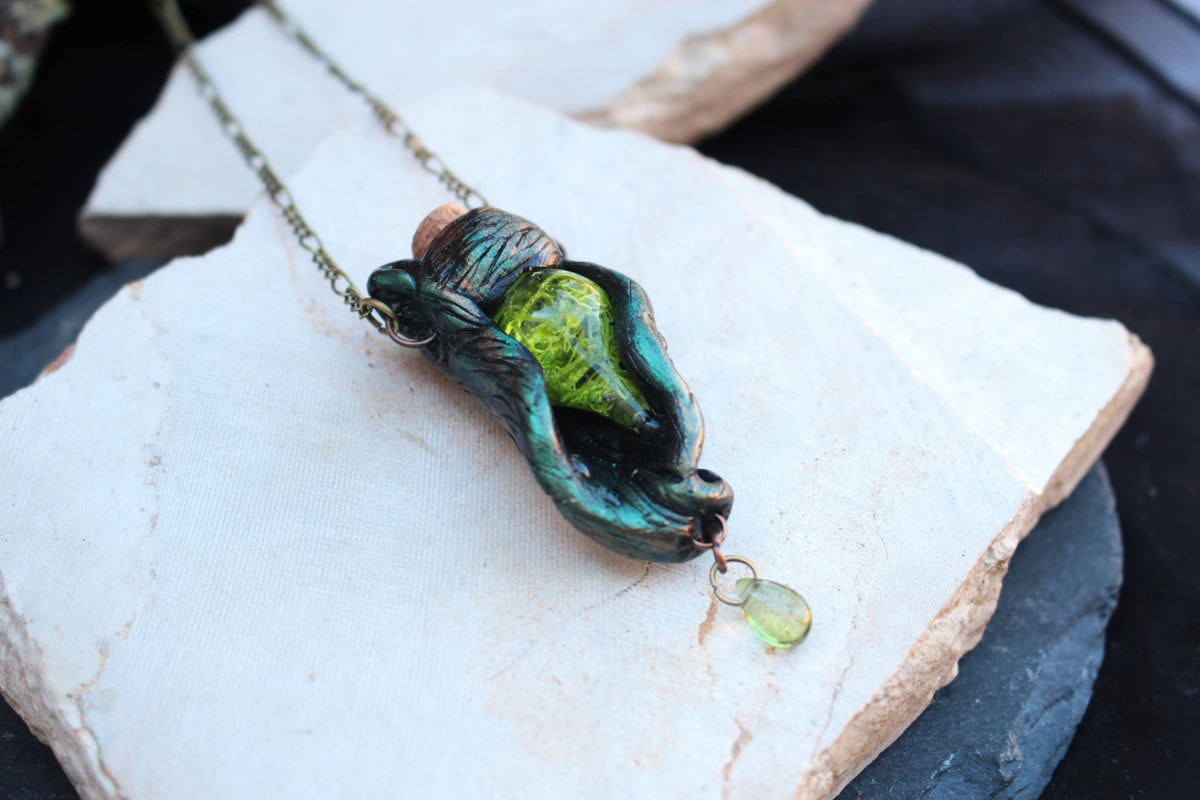 Handmade druid necklace featuring a green vial wrapped in leaves