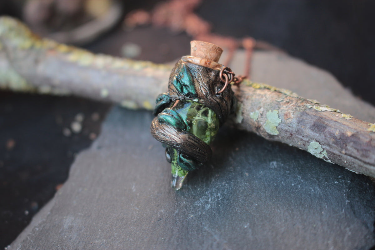 Fantasy-inspired handmade necklace featuring a tiny moss potion bottle