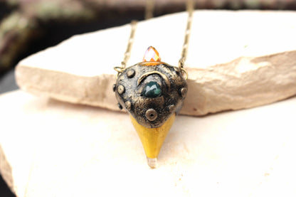 Detailed view of a polymer clay fantasy pendant with bronze finish
