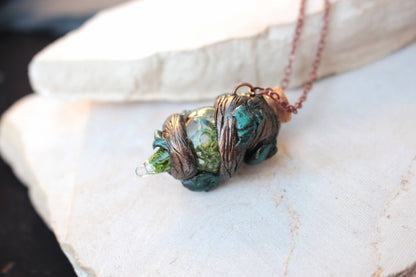 Handmade fantasy jewelry featuring a tiny decorative potion bottle and woodland details