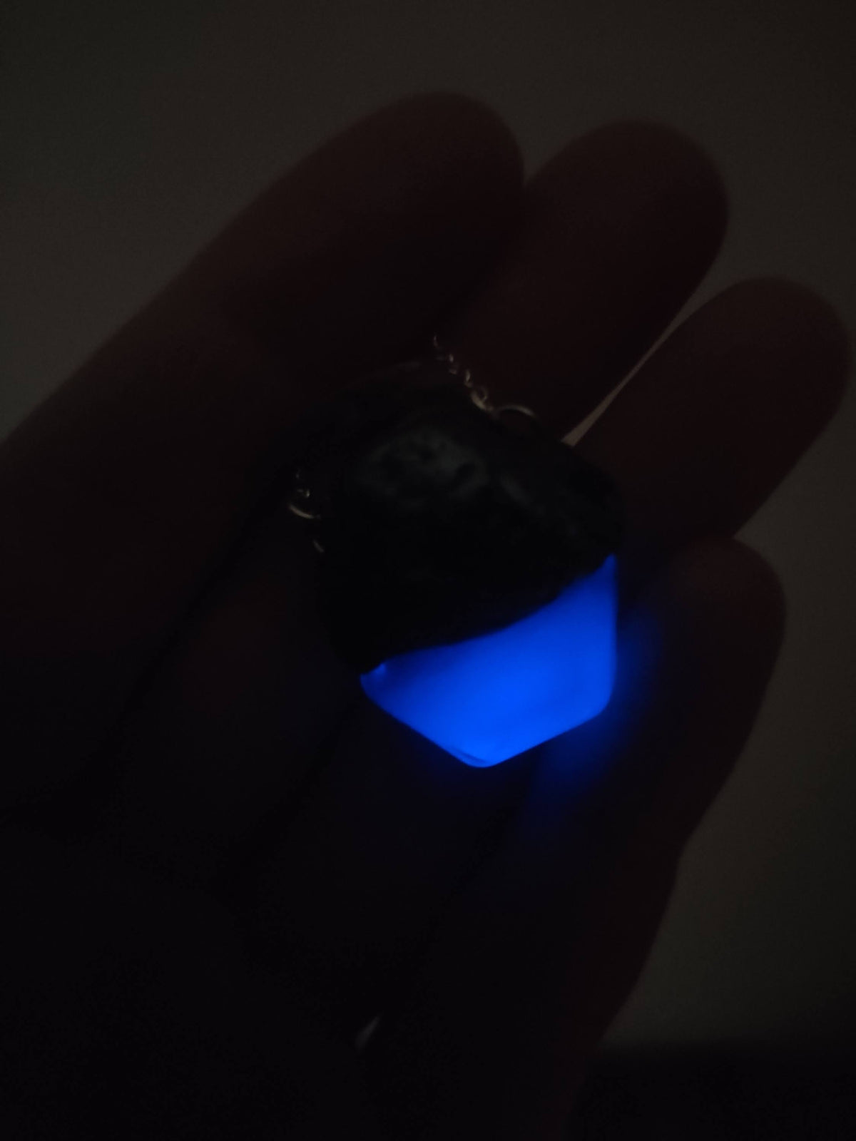 Handmade glowing blue potion jewelry with bronze finish and green accents