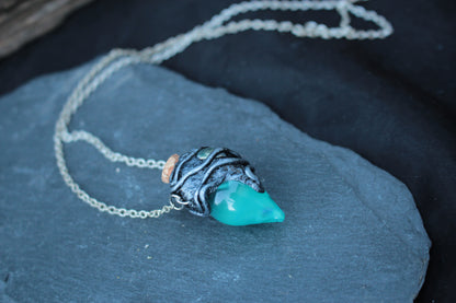 Handmade magic potion necklace with glowing turquoise vial