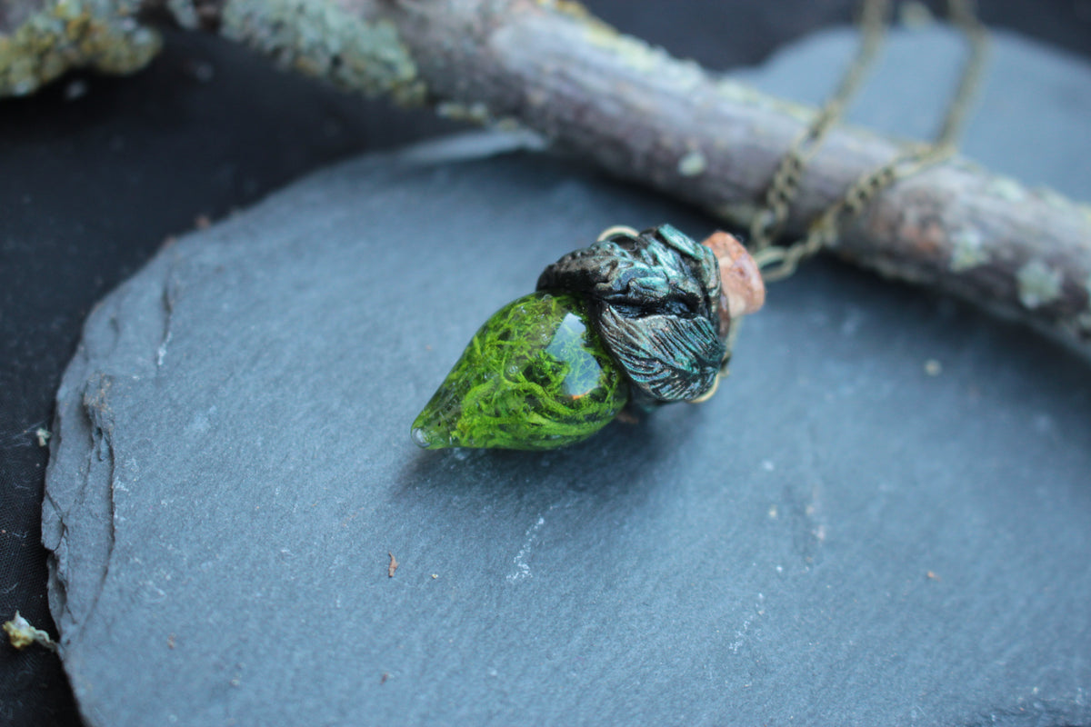 Handmade glass vial necklace filled with vibrant green artificial moss