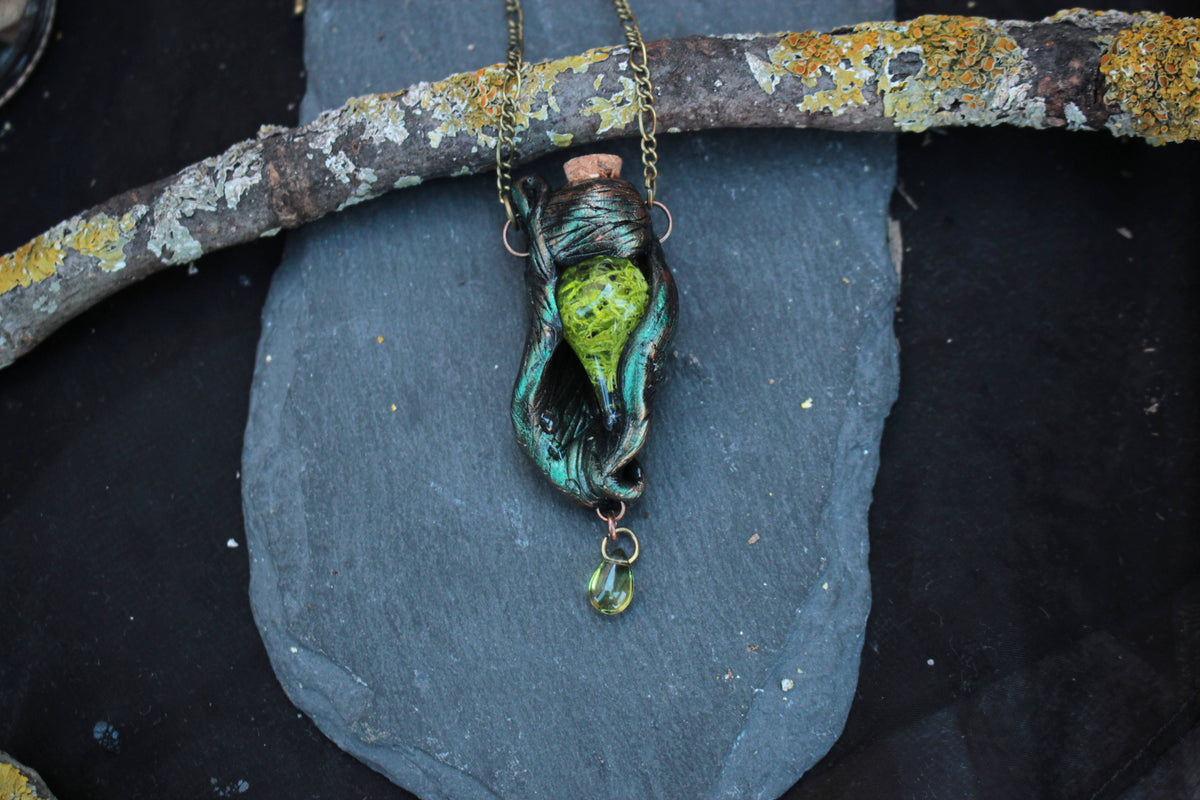 Handmade nature inspired fantasy jewelry with a green forest vial