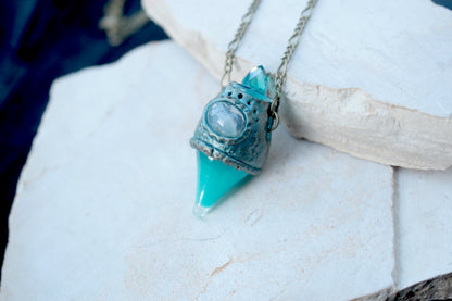 Handmade potion bottle jewelry with a luminous turquoise detail