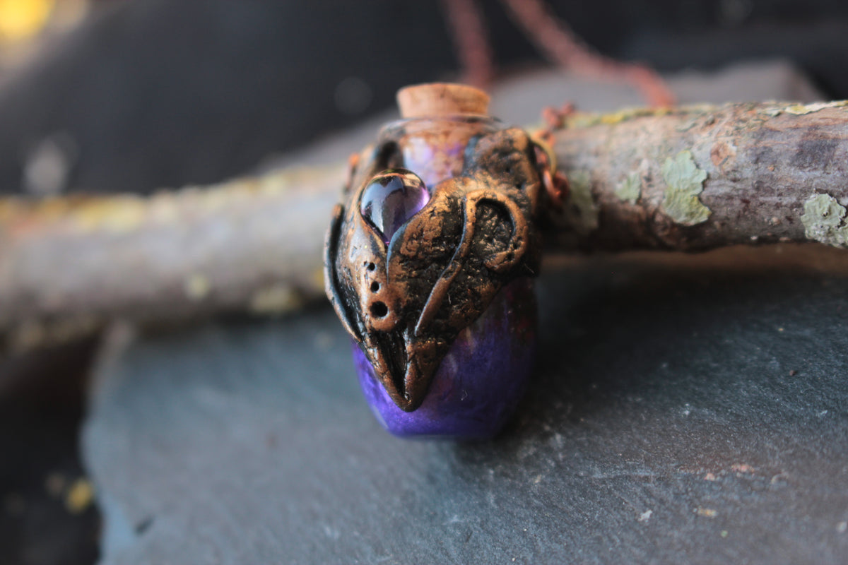 Handmade polymer clay potion jewelry featuring a violet vial and crystal