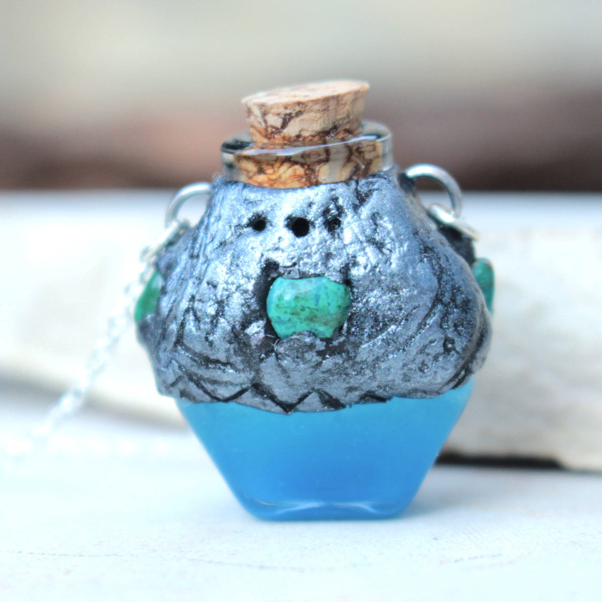 Magical blue vial jewelry with a glowing effect and antique-style details