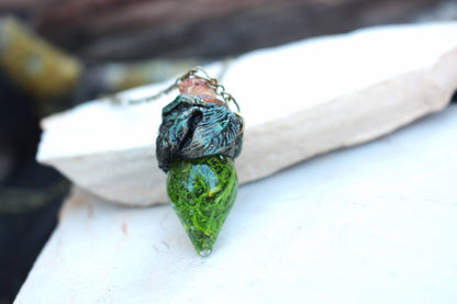 Magical forest-inspired jewelry with a glowing green moss-filled vial
