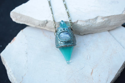 Magical turquoise necklace with a miniature potion pendant and bronze finish