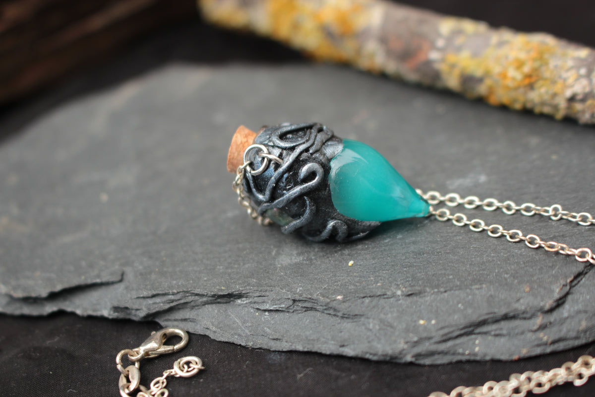 Turquoise fantasy potion bottle necklace with a magical fluorescent glow
