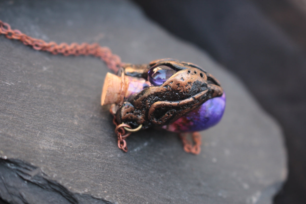 Medieval-inspired fantasy necklace with an ornate bronze potion bottle