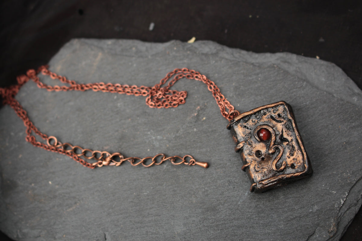 Miniature handmade spell book pendant with rustic antique-style details