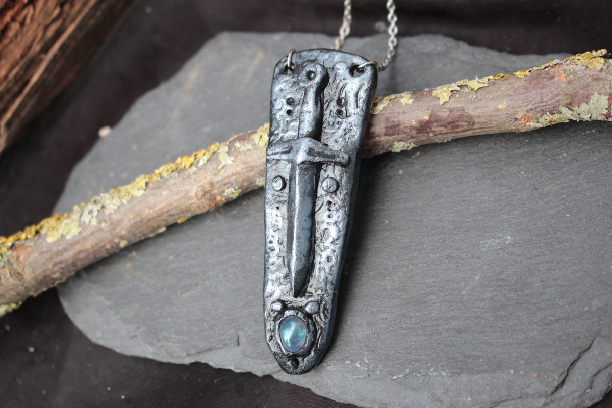 Fantasy sword necklace with an iridescent gemstone