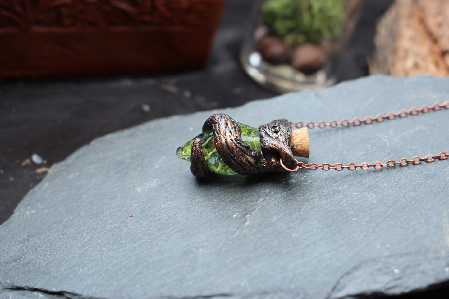 Handmade glass bottle pendant filled with decorative moss