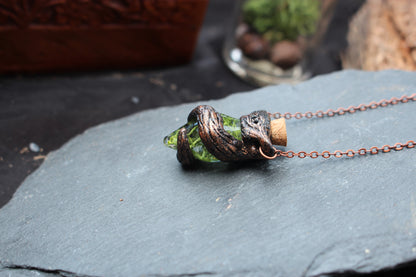 Handmade glass bottle pendant filled with decorative moss