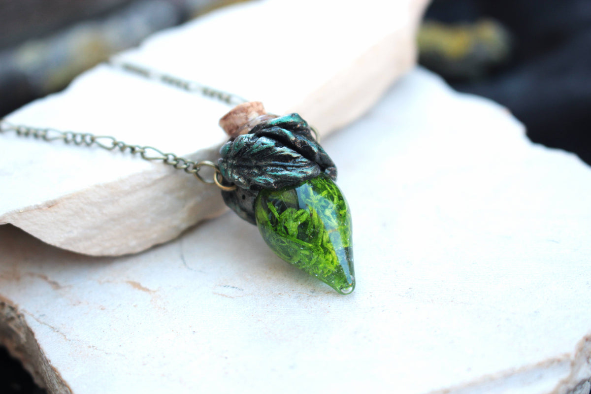 Moss-filled glass vial necklace with a cork stopper and metal chain