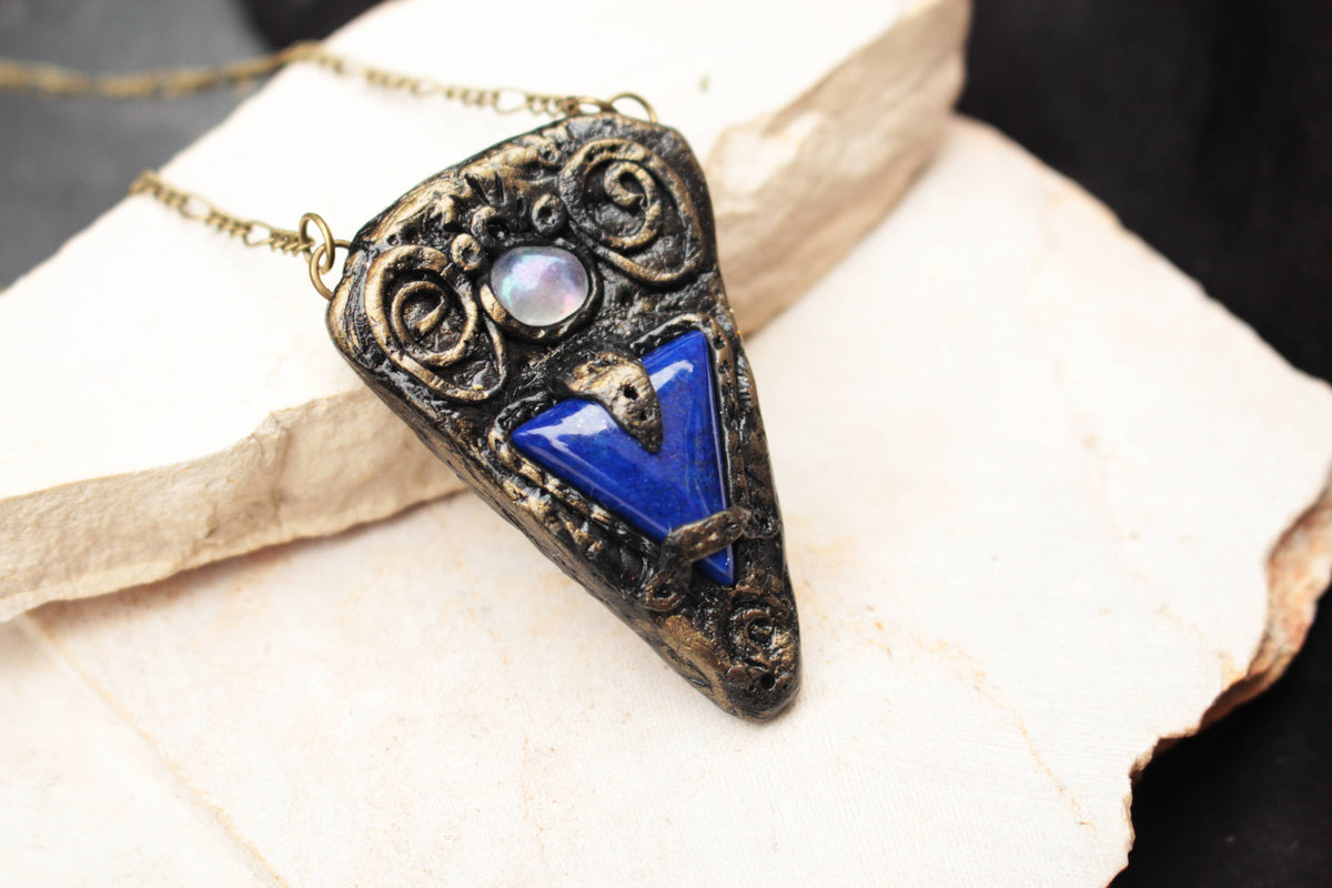 Mystical handmade necklace with a deep blue gemstone and fantasy-inspired design