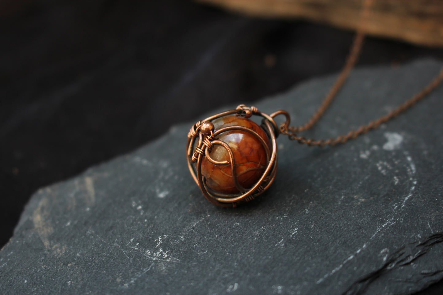 Natural dragon vein agate cabochon wrapped in artistic copper wire
