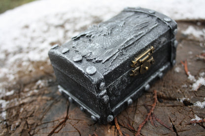 RPG dice box opened showing metal dice set inside