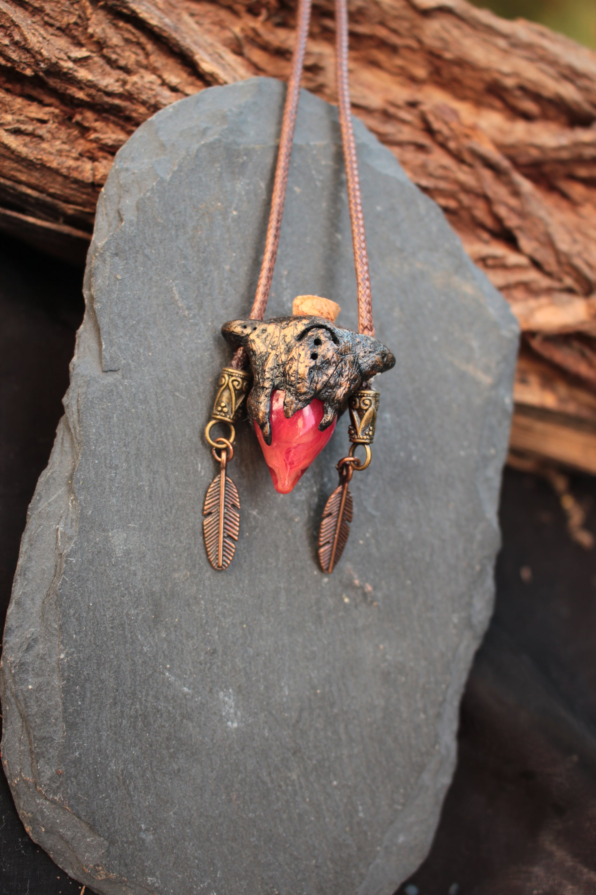 Red potion bottle pendant necklace decorated with feather charms