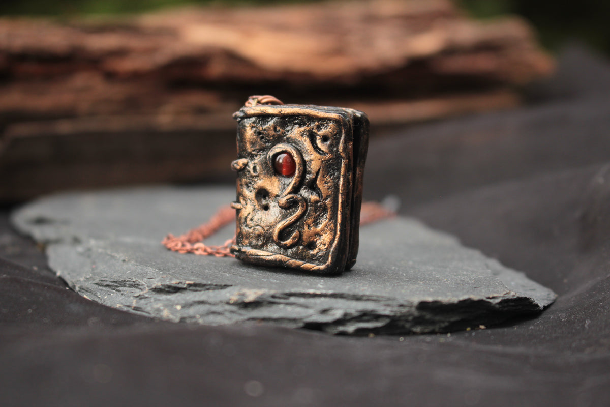 Handmade RPG inspired magic book pendant with carnelian stone