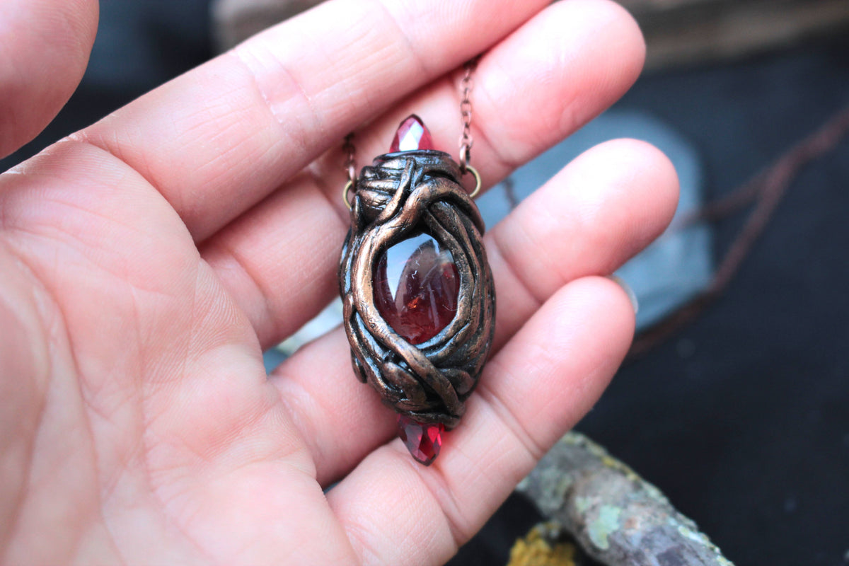 Handmade red crystal jewelry inspired by ancient magical artifacts