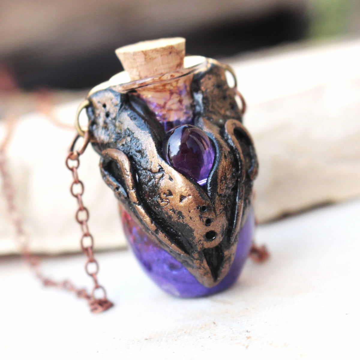 Handmade fantasy potion necklace with a violet glass vial and bronze details