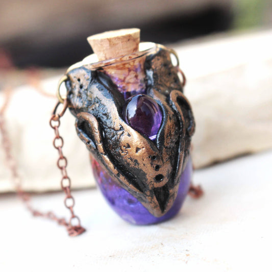 Handmade fantasy potion necklace with a violet glass vial and bronze details