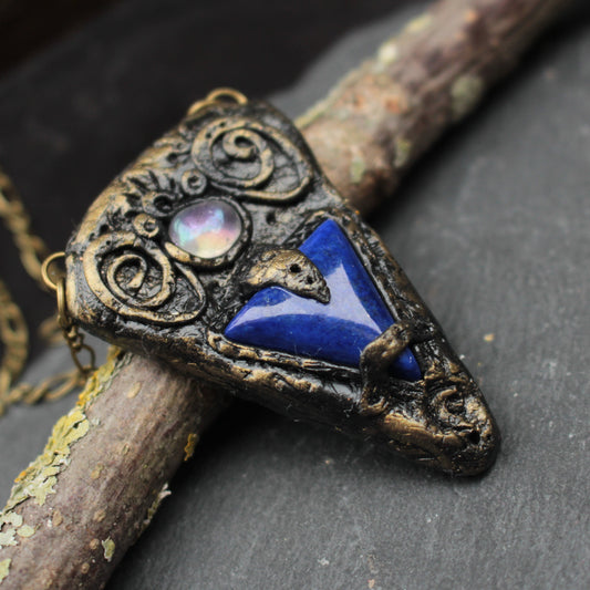 Handmade fantasy necklace featuring a mysterious blue gemstone talisman