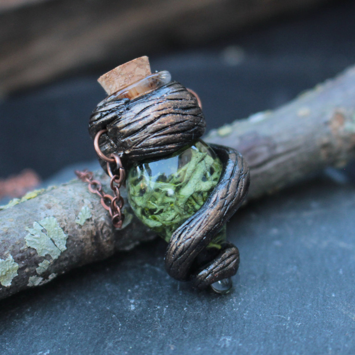 Green fantasy vial necklace with woodland-inspired design and twisted bark details