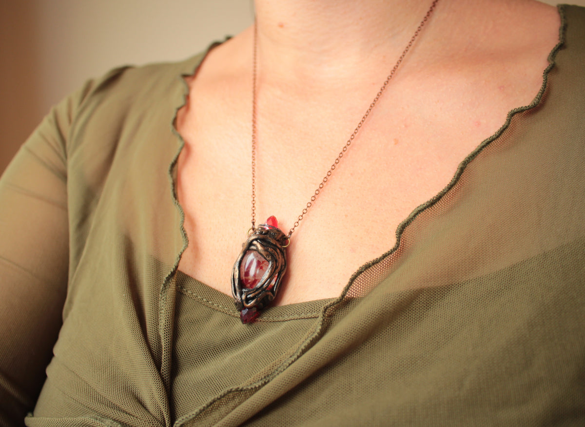 The Three Blood Crystal amulet, a handmade fantasy necklace inspired by an ancient legend