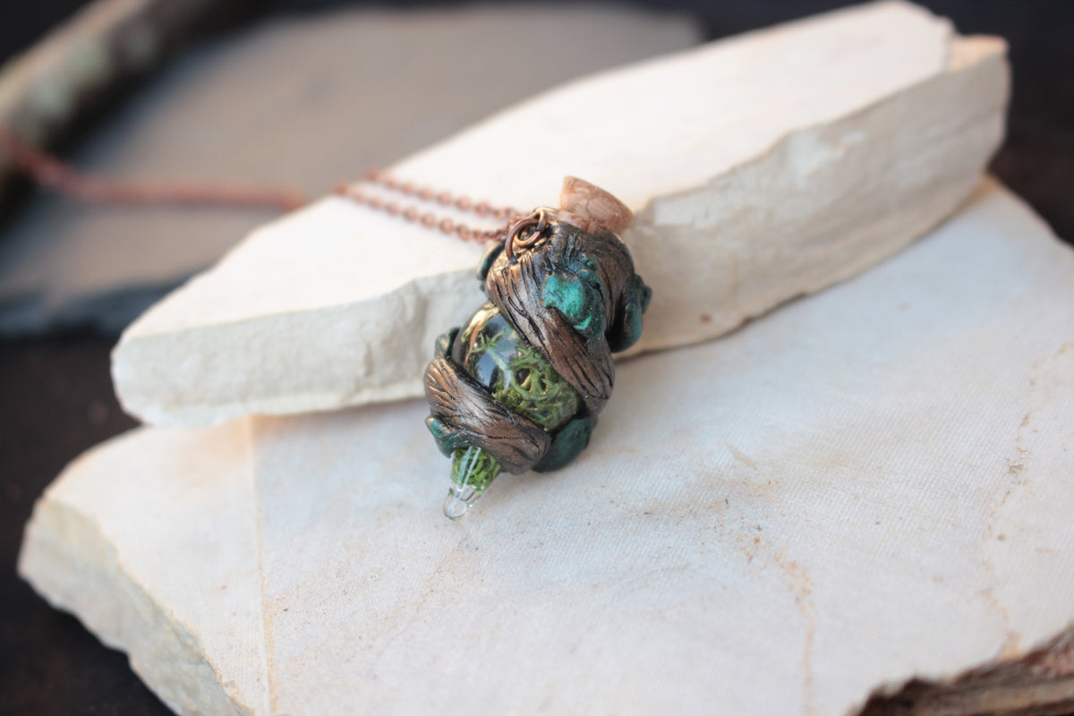 Tiny forest-inspired potion pendant on a handmade fantasy necklace