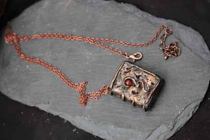 Tiny handmade spellbook necklace with detailed rustic cover