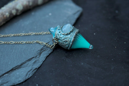 Handmade turquoise fantasy jewelry featuring a miniature glowing potion bottle