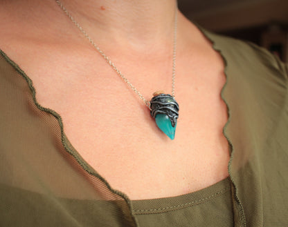 Fantasy jewelry necklace featuring a turquoise potion bottle that glows green in darkness