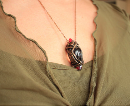 One-of-a-kind fantasy necklace featuring red crystals and an enchanted antique-style finish