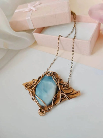 Artistic wire wrapped blue opal gemstone pendant handcrafted from polished copper